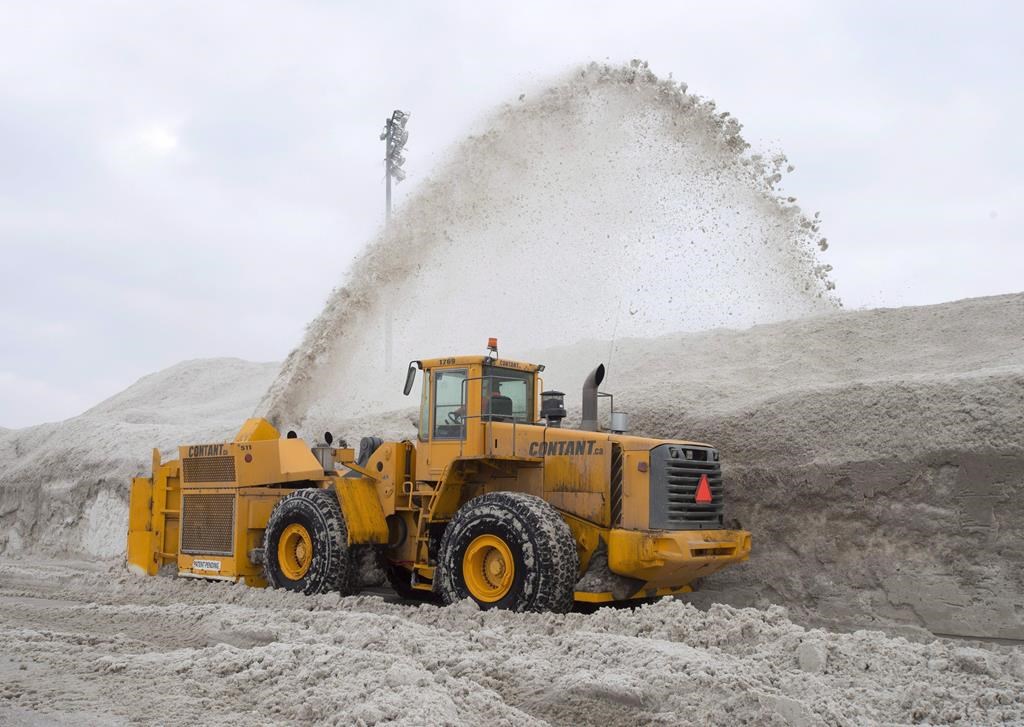 In this file photo, a snowblower piles snow at the city's newest dump at Blue Bonnets as snow removal operations continue in Montreal on February 14, 2018.