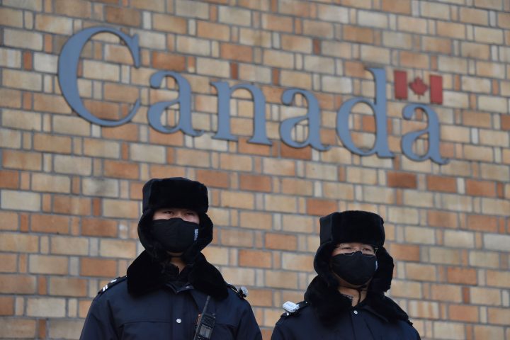 Chinese police officers stand guard outside the Canadian embassy in Beijing on December 10, 2018.