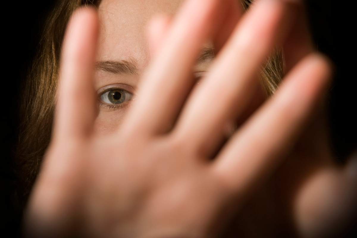 A woman's hands in front of her face.