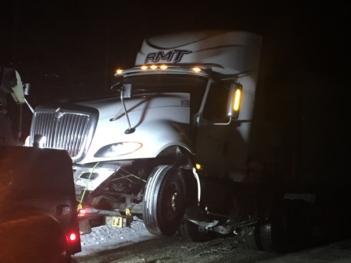 A semi being pulled by tow truck on Highway 33 on Thursday night. 