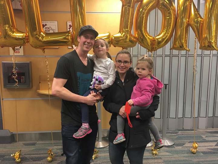 Joey Hidber is greeted by his family at Kelowna Internatinal Airport.  He was the two millionth passenger to pass through the airport this year.