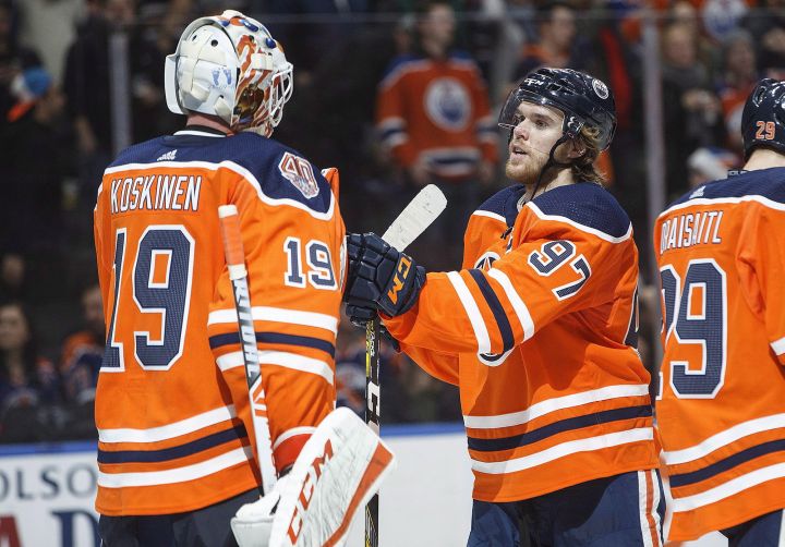 Edmonton Oilers goalie Mikko Koskinen (19) and Connor McDavid (97) celebrate the win over the Philadelphia Flyers during third period NHL action in Edmonton, Alta., on Friday December 14, 2018.