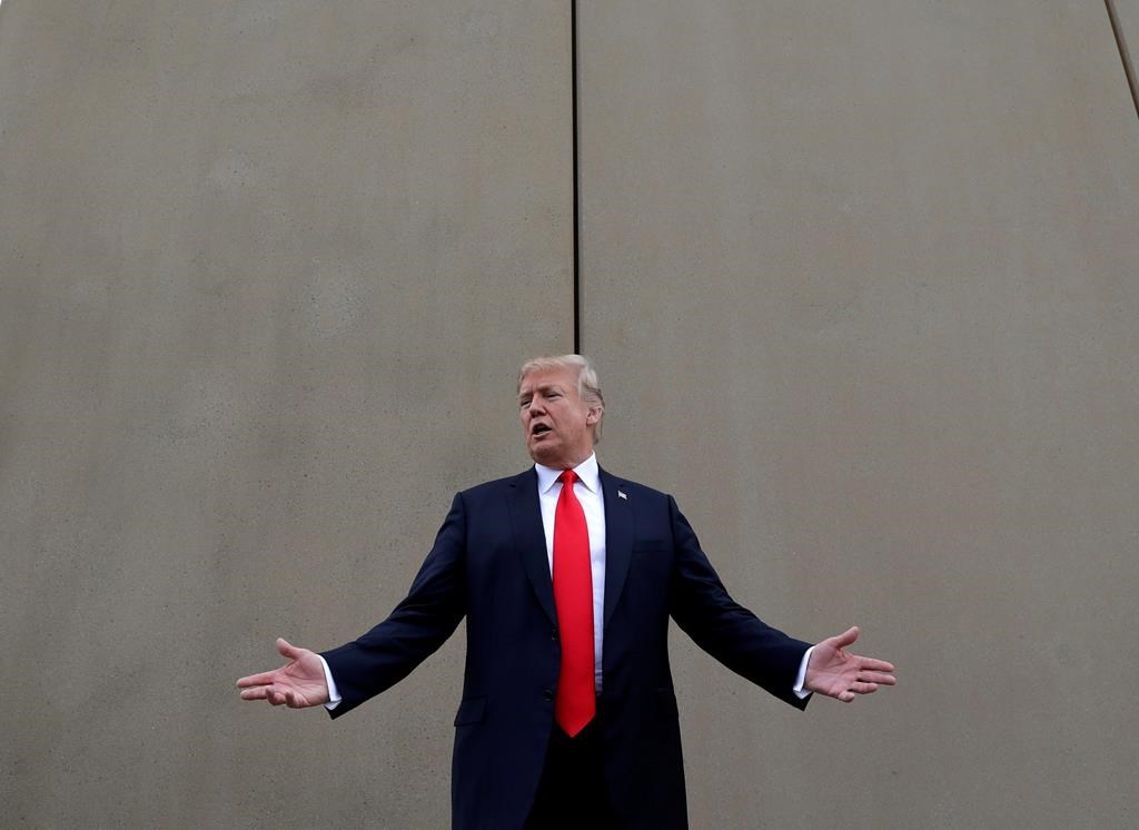 FILE - In this March 13, 2018, file photo, President Donald Trump speaks during a tour as he reviews border wall prototypes in San Diego.
