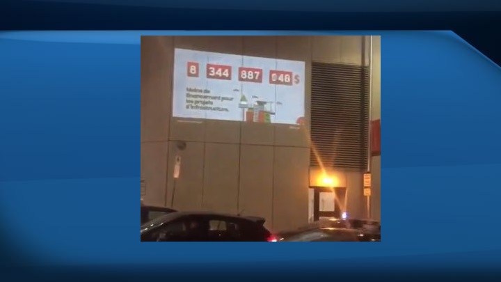 On Wednesday, Alberta Premier Rachel Notley tweeted a 10-second video in which the person capturing the images pans across a parking lot before focusing on a wall with a message projected on it.