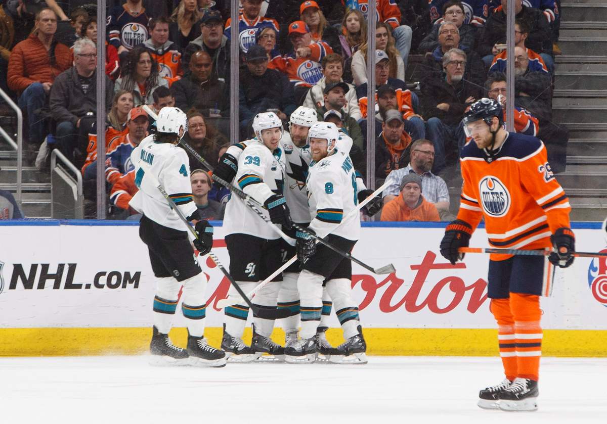 San Jose Sharks celebrate a goal as Edmonton Oilers’ Leon Draisaitl (29) skate past during second period NHL action in Edmonton on Saturday December 29, 2018.