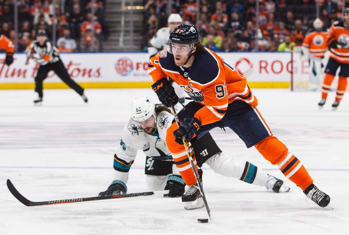 San Jose Sharks’ Erik Karlsson (65) tries to catch Edmonton Oilers’ Connor McDavid (97) during second period NHL action in Edmonton on Saturday December 29, 2018.