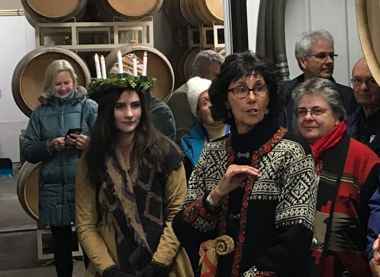 Margaret Holm explaining the significance of the Santa Lucia Festival of Lights at the Okanagan Centre of the Royal Astronomical Society of Canada (OCRASC) Winter Solstice Celebration held at Township 7 Winery.