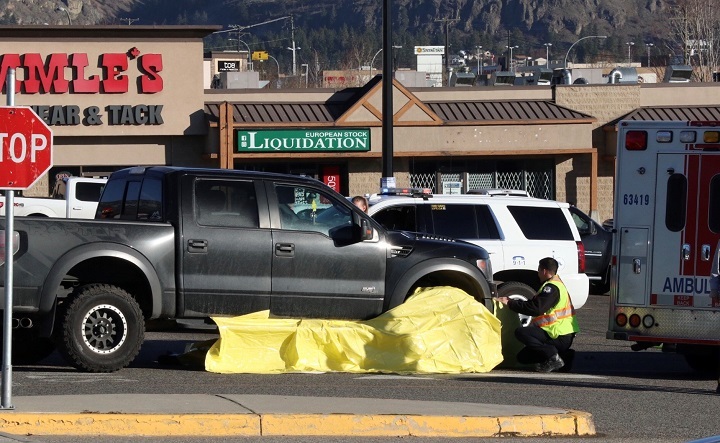 Emergency crews cover part of a truck with yellow bags following an accident in West Kelowna on Saturday.