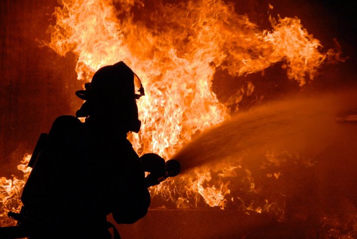 A firefighter battles a blaze.
