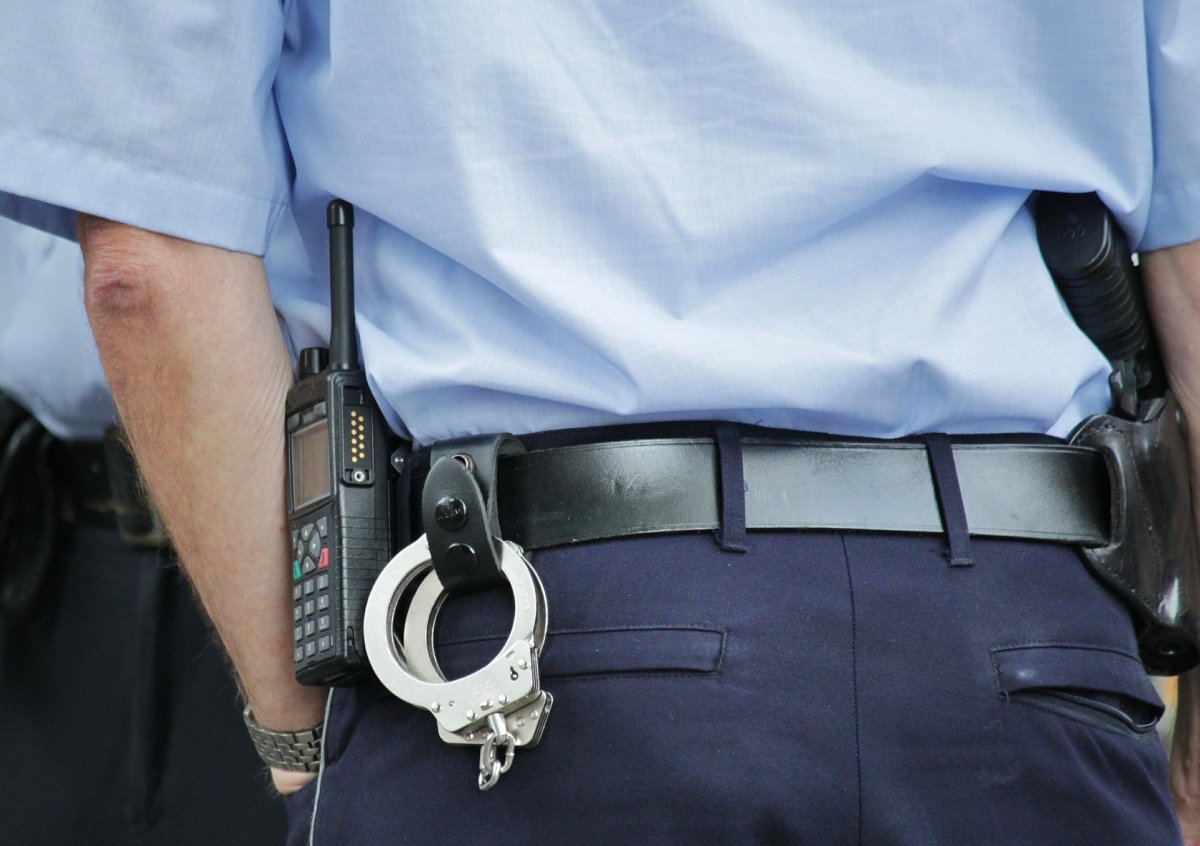 An officer with handcuffs.