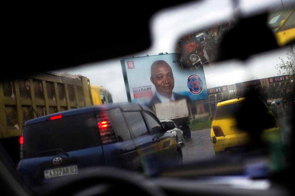 A poster featuring ruling party presidential candidate and former interior minister Emmanuel Ramazani Shadary is displayed on the road leading to the airport in Kinshasa, Democratic Republic of the Congo on Dec. 17, 2018.