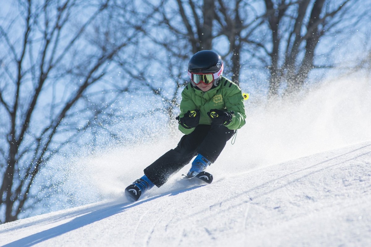 A boy skis down a hill.