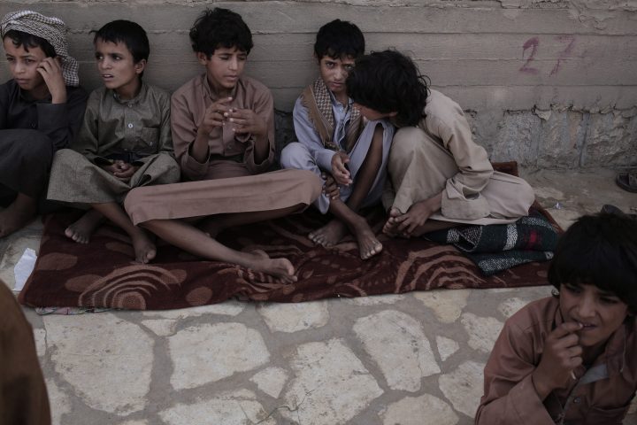 In this July 27, 2018, photo, 14 year-old Abdel Hamid, second right, and 14 year-old Morsal, third right, sit at a camp for displaced persons where they took shelter, in Marib, Yemen.