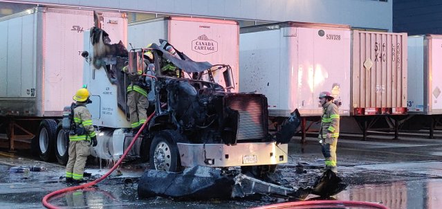 Richmond fire crews extinguish a fire in a truck cab on Friday.