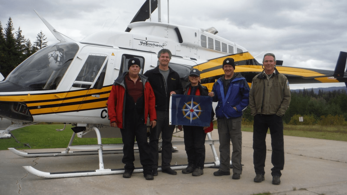 September exploration team holding the Royal Canadian Geographical Society Flag. Left to right: John Pollack, Ken Lancour, Catherine Hickson, Lee Hollis, Tod Haughton. Caver Chas Yonge also worked on the expedition, assisting by remote.
