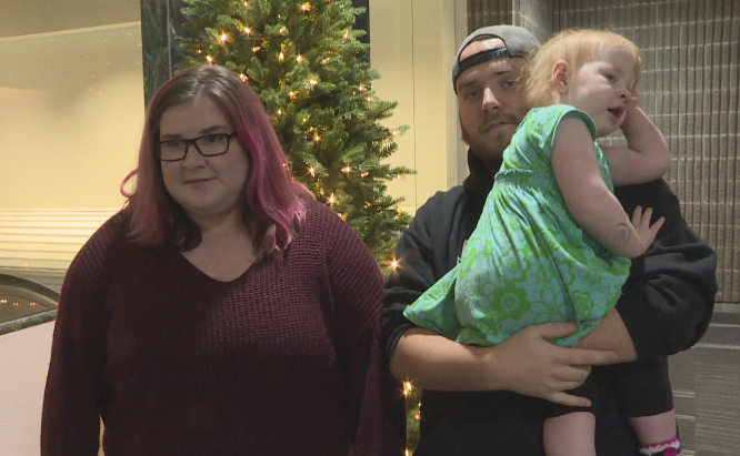 Hilarie Zamkotowich being held by her father Morgan Hobbs along with her mother Sara Zamkotowich.