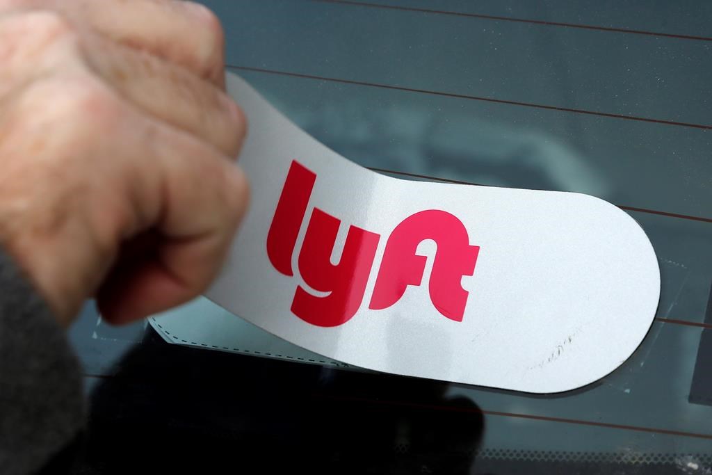 In this Jan. 31, 2018, file photo, a Lyft logo is installed on a Lyft driver's car in Pittsburgh. Saskatchewan has approved ride-hailing regulations but it could be a while before companies and drivers hit the road in the province's two biggest cities.