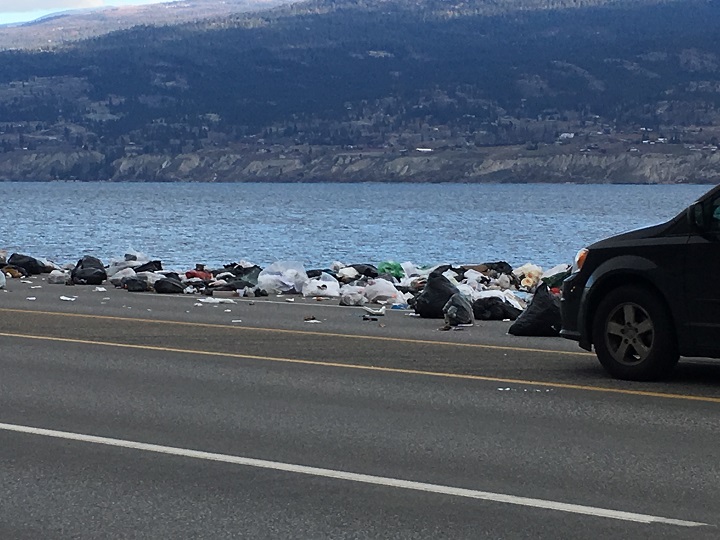 Garbage lays alongside Okanagan Lake and Highway 97 on Friday.