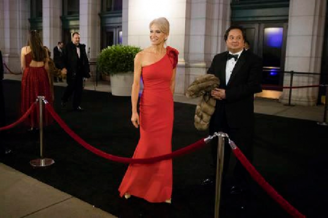 Kellyanne Conway and her husband George speak with members of the media as they arrive for a dinner at Union Station in Washington, the day before President Donald Trump's inauguration, Jan. 19, 2017.