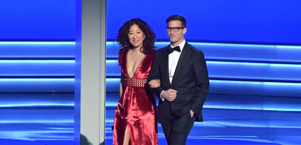 Sandra Oh (L) and Andy Samberg walk onstage during the 70th Emmy Awards at Microsoft Theater on Sept. 17, 2018, in Los Angeles, Calif. 