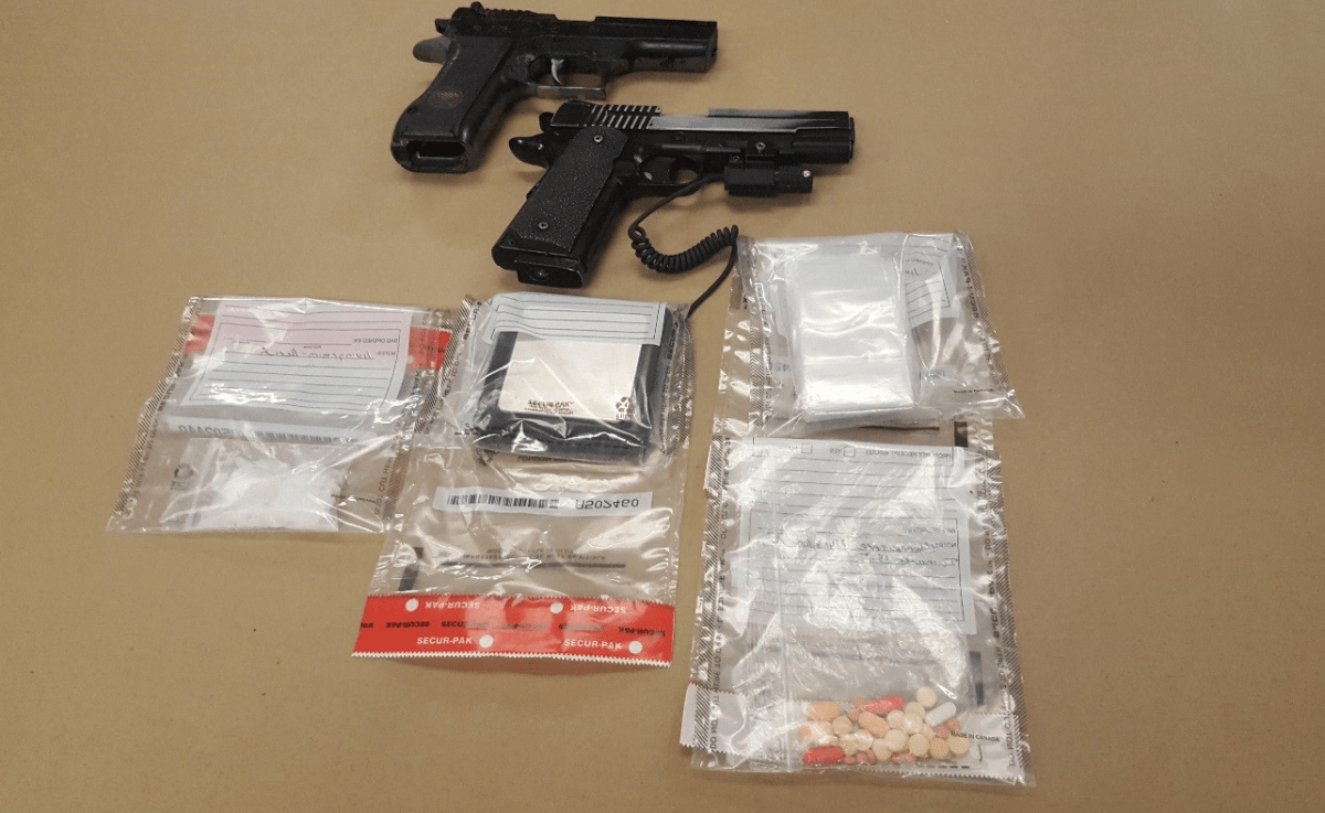 A London couple is facing charges after police seized replica guns and a variety of drugs.