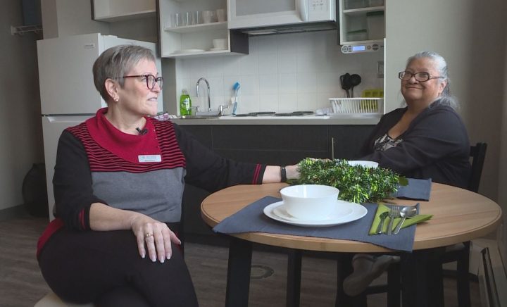 Diana Krecsy, president and CEO of the Calgary Homeless Foundation, and Diane Gautchier, a member of the client action committee with the Calgary Homeless Foundation, sit in one of the Maple’s units.