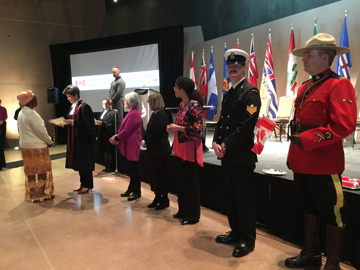 Canada's newest citizens lining up to receive their citizenship certificates at the Canadian Museum for Human Rights.