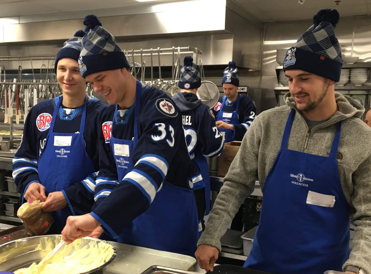 Players from the Manitoba Moose rolled up their jersey sleeves to help out a Siloam Mission Wednesday.