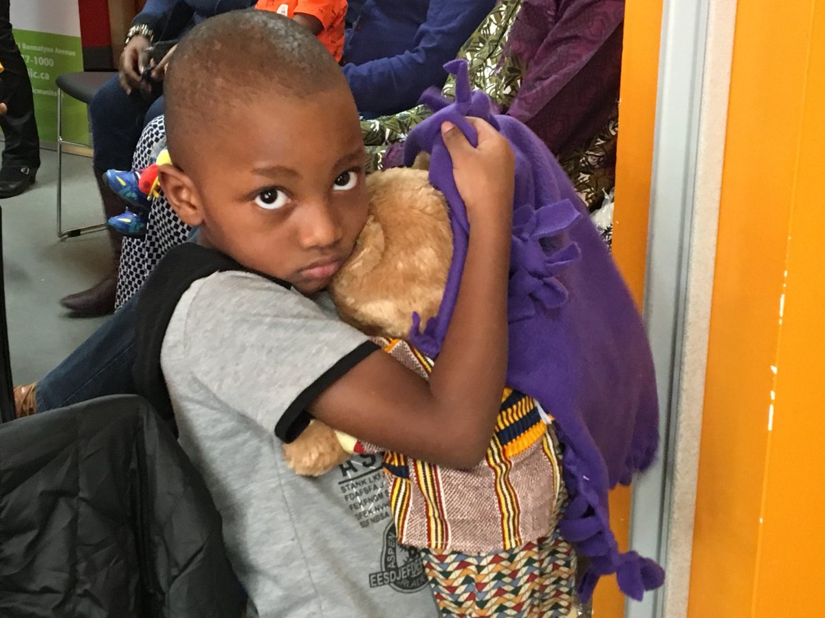 Four-year-old Manzi Tibert holding his new teddy bear.
