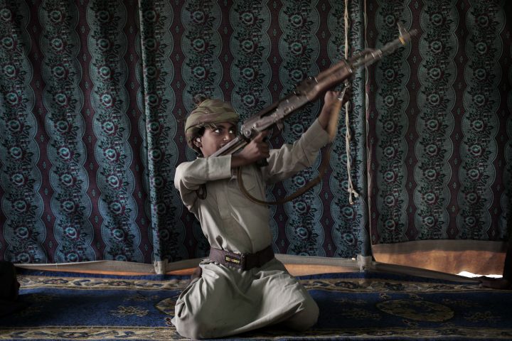 Kahlan, a 12-year-old former child soldier, demonstrates how to use a weapon, at a camp for displaced persons where he took shelter with his family, in Marib, Yemen in this July 27, 2018 photo.