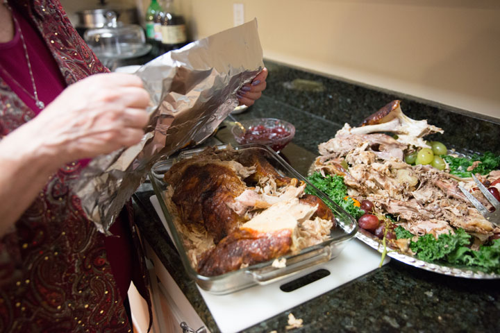 File: A woman wraps up a leftover turkey dinner.