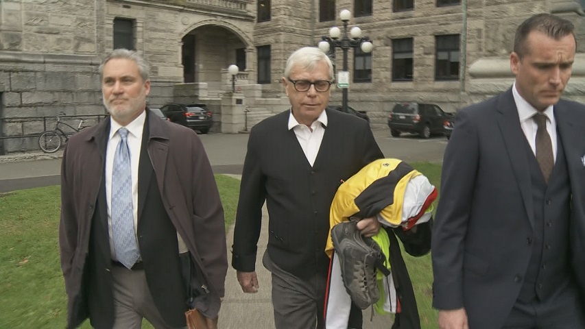 Clerk of the legislature Craig James and Sergeant-At-Arms Gary Lenz are escorted from the building in what has shaped up to be one of the more mysterious B.C. political stories of 2018.