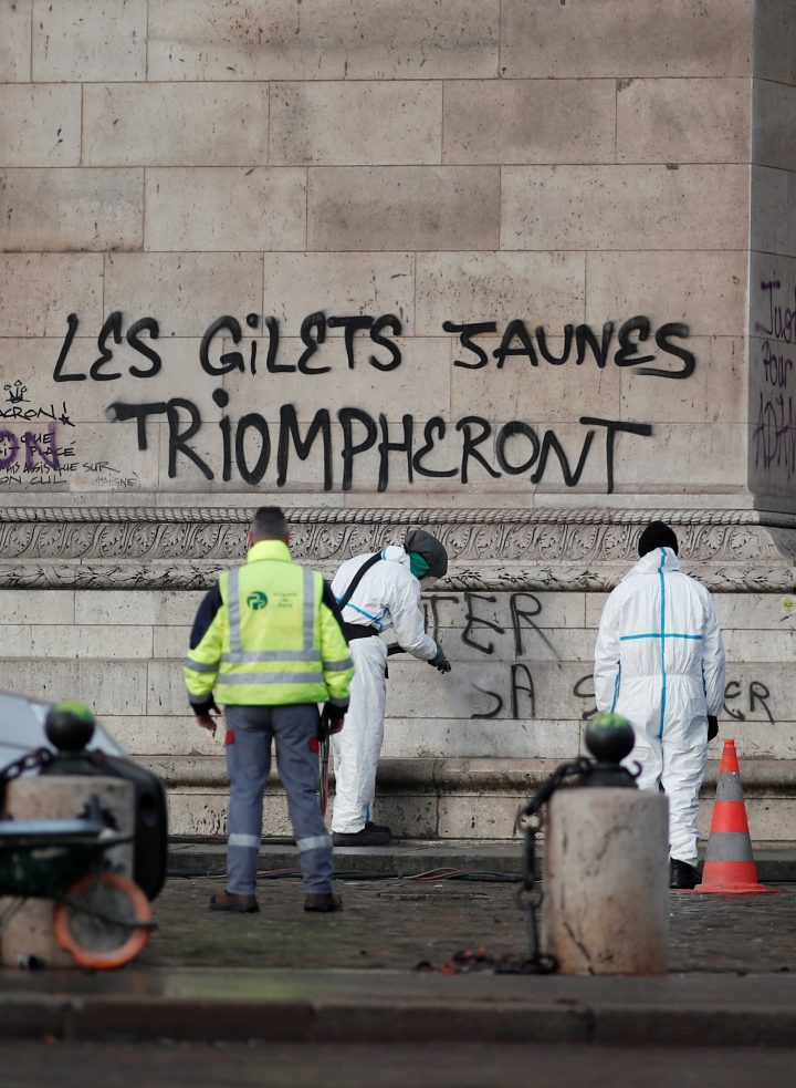Cleanup operations continue under the message, “The Yellow Vests will Triumph” written on the Arc de Triomphe, in Paris, France, Dec. 2, 2018.