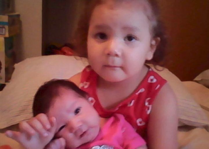 An undated photo of Mary Lafleche Petawaysin (in the pink shirt) and Mackenzie Petawaysin (in the red shirt).