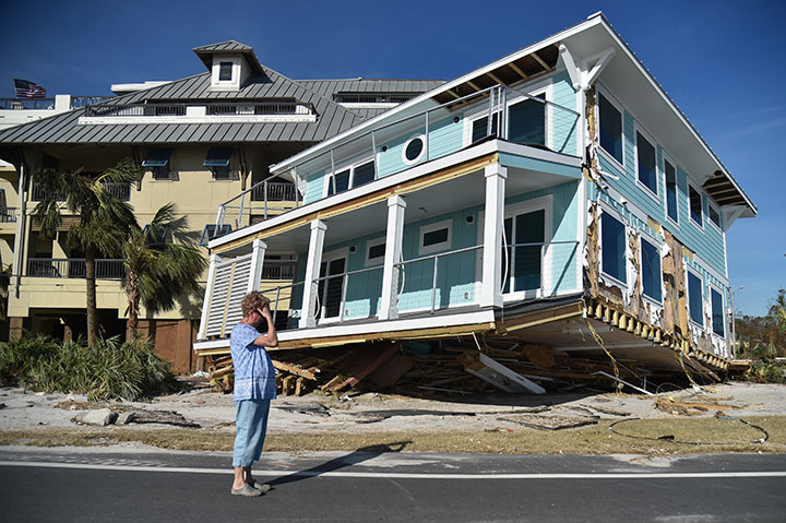 A woman mourns as she sees the damage caused by Hurricane Michael in Mexico Beach, Florida on October 12, 2018.