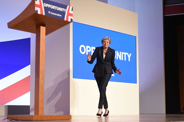 British Prime Minister Theresa May dances a few steps as she takes the stage to give her keynote address on the fourth and final day of the Conservative Party Conference 2018 in Birmingham on October 3, 2018.
