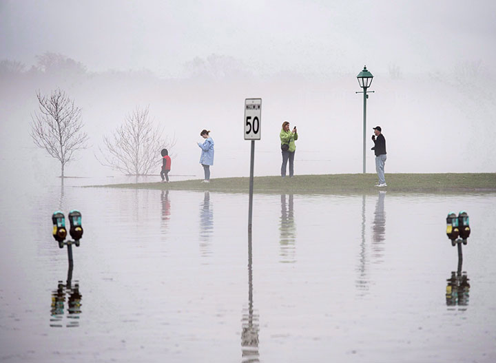 Fog shrouds the waterfront as the St. John River water levels rise faster than normal around Fredericton, pushing the river past the flood stage in the New Brunswick capital on Saturday, April 28, 2018.