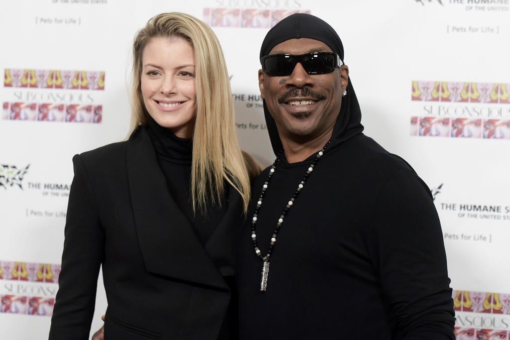 Paige Butcher, left, and Eddie Murphy attend "SUBCONSCIOUS" by Bria Murphy Gallery Opening at Lace Gallery in Los Angeles.