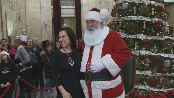 Montreal Mayor Valérie Plante poses with Santa Claus at the annual holiday open house at city hall. Saturday, Dec. 22, 2018.