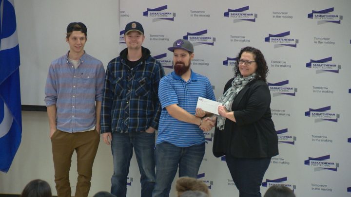 Eric Mooney and his team give donation to Saskatoon Food Bank and Learning Centre executive director, Laurie O’Connor.