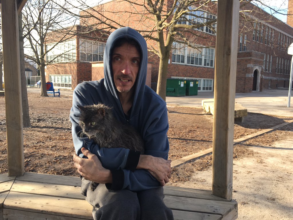 Sean Gregory with his cat Smokey Bear following a fire at 15 St. Andrew Street on Wednesday, Dec. 19, 2018. He lived in the building and thought the 19-year-old cat had perished in the blaze, but he was rescued by firefighters after the fire was extinguished.
