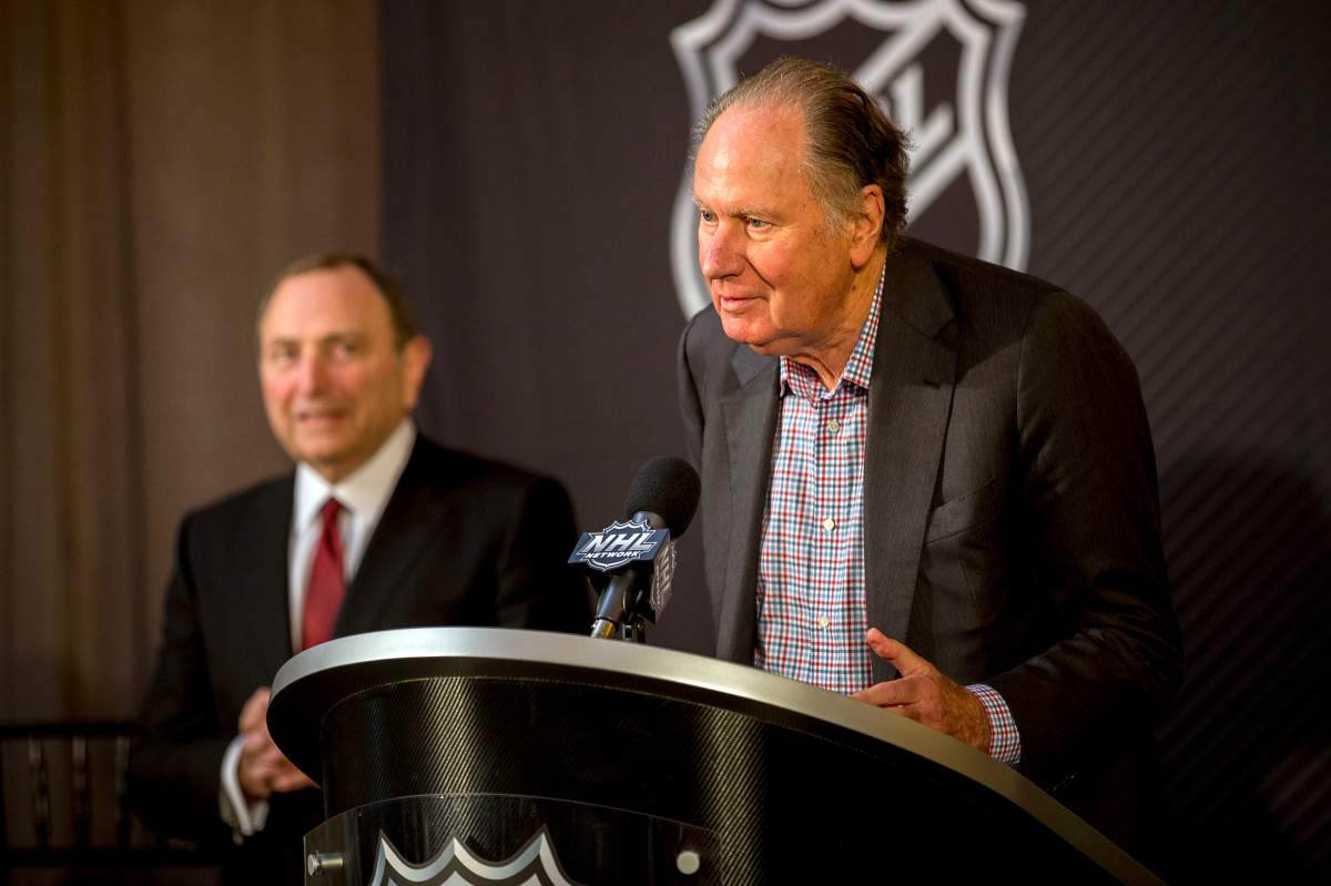 New Seattle hockey franchise majority owner David Bonderman, right, steps up to the podium after the National Hockey League Commissioner Gary Bettman, left, named Seattle as the league's 32nd franchise, Tuesday, Dec. 4, 2018, in Sea Island, Ga.