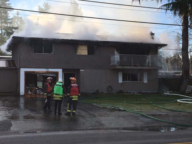 Fire crews on scene at a house fire near 133A Street and 112 Avenue on New Year’s Eve. Credit: Tony Clark / Global News