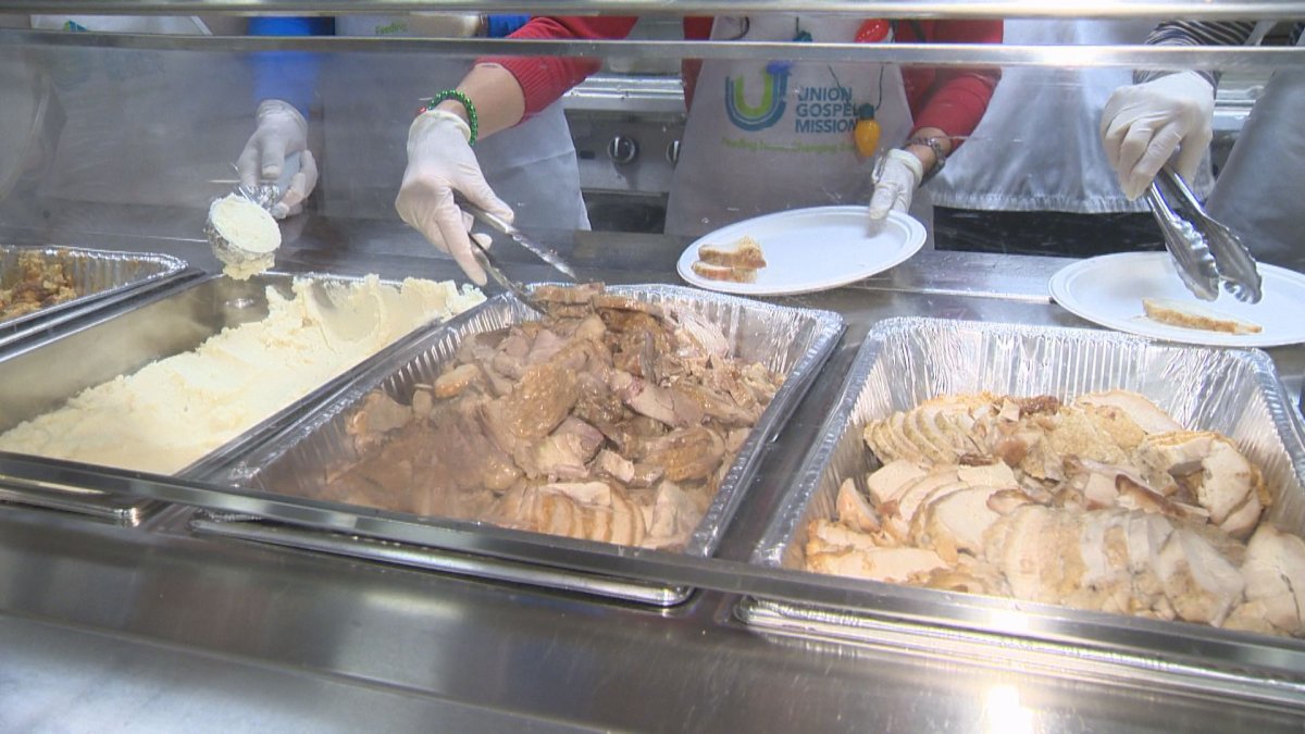 Volunteers dish up turkey and mashed potatoes for an estimated 2,500 to 3,000 people. 