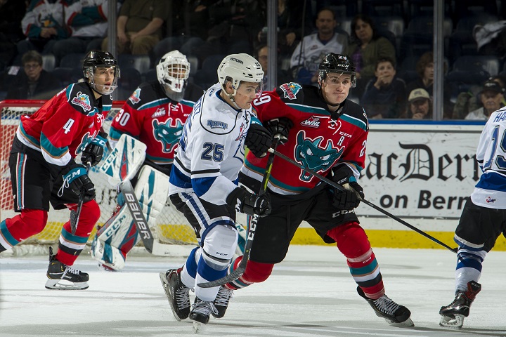 Nolan Foote of the Kelowna Rockets, right, and Dino Kambeitz of the Victoria Royals jockey for position during first-period WHL action in Kelowna, B.C., on Friday night.