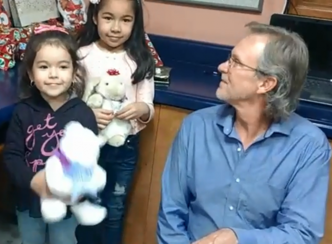 Randy Heiss meets Dayami, whose Christmas wish list floated over the U.S.-Mexico border wall, and her sister Ximena at a radio station in Nogales, Mexico, Dec. 20, 2018, in this screen grab taken from a Facebook video.