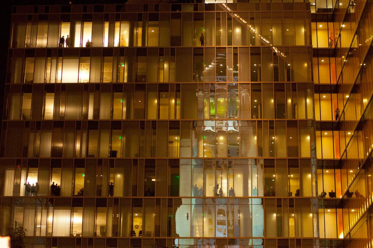 Los Angeles Police Department officers and employees watch the Occupy LA protest from the LAPD Headquarters across the street in Los Angeles on Tuesday, Nov. 29, 2011. 