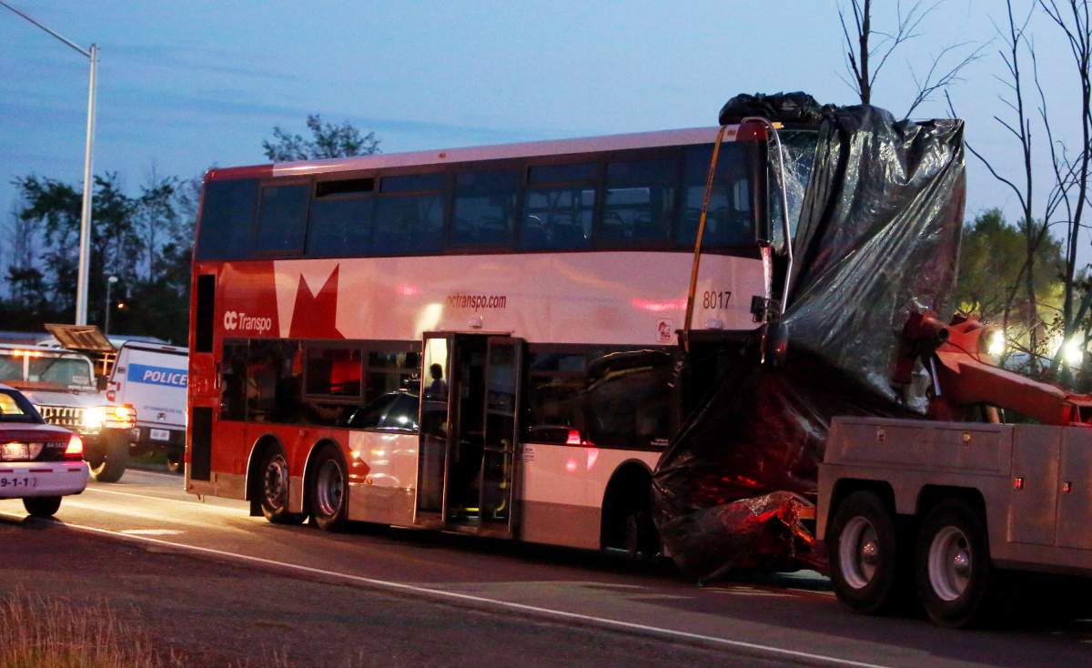 The bus in which six people died is towed away from the site of the fatal bus and train crash in Ottawa, Thursday, September 19, 2013. Six people died in the crash between a Via Rail train and a city bus on Wednesday.