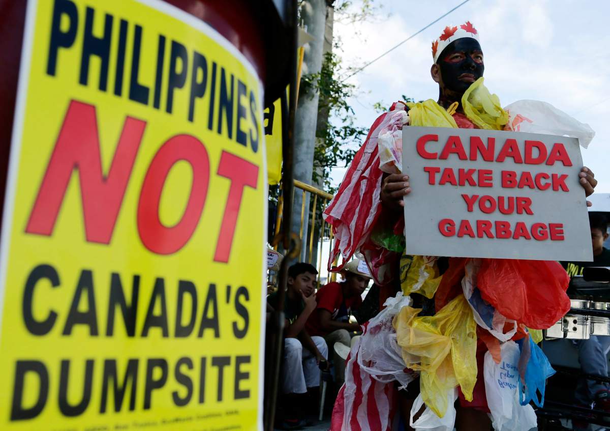 Filipino environmentalists hold a demonstration in front of the Senate building in protest of garbage imported from Canada.