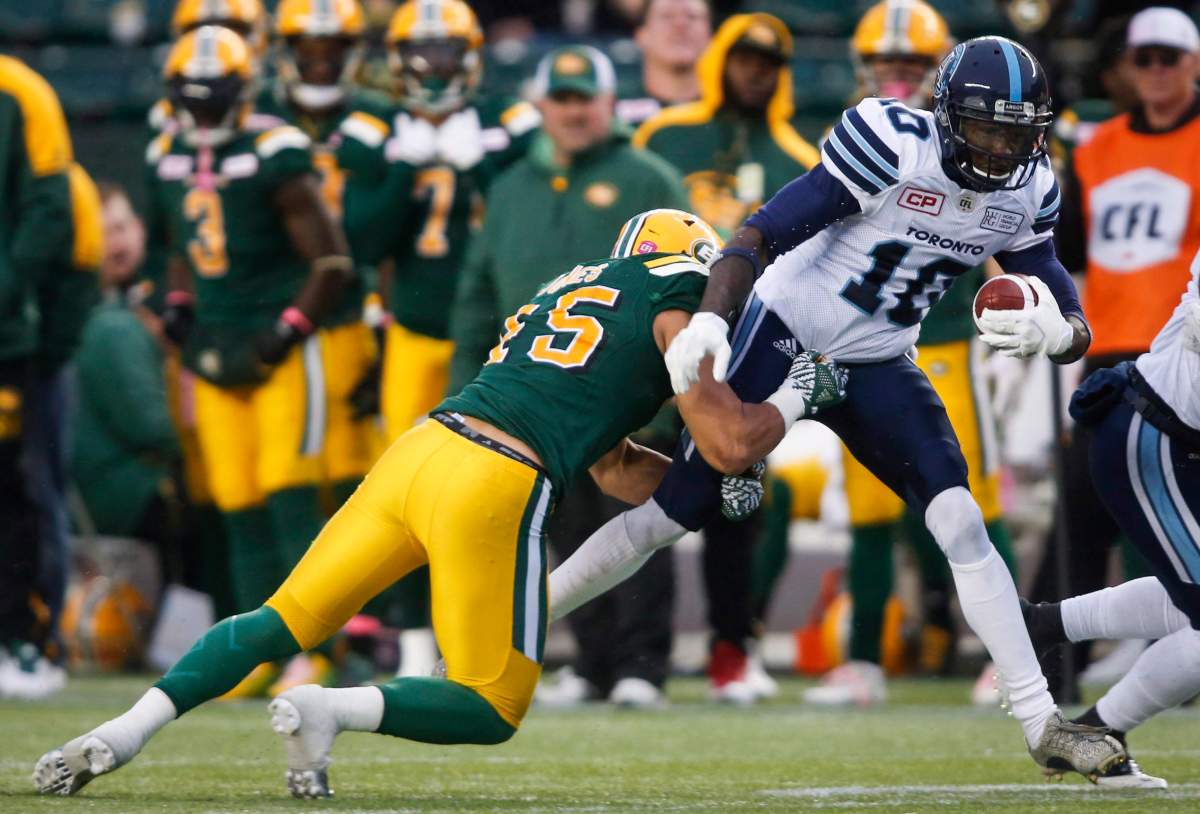 Toronto Argonauts' Armanti Edwards, right, is tackled by Edmonton Eskimos' Korey Jones during first half CFL football action in Edmonton, Saturday, Oct. 14, 2017. https://globalnews.ca/news/4865092/eskimos-sign-three-players/.